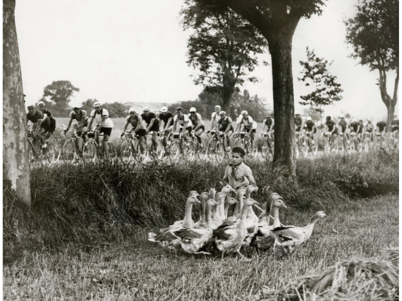 a boy with kids along le Tour de France