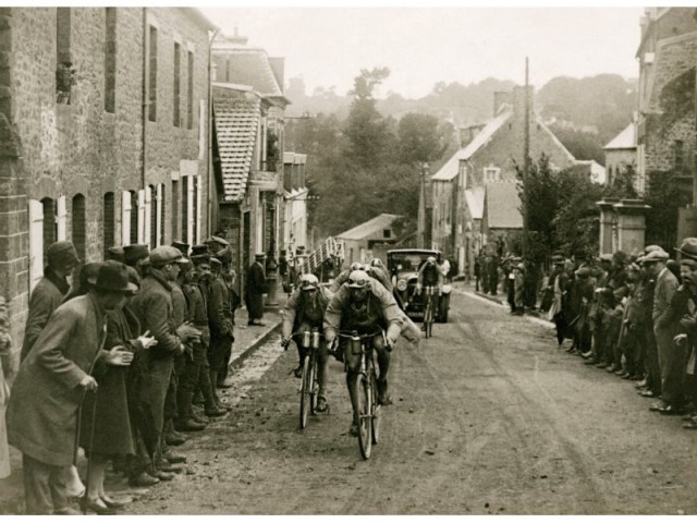 tour de france racing through a village