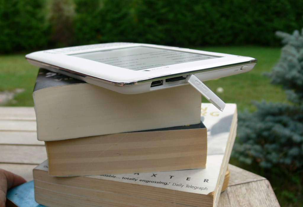 elonex ereader, stack of books