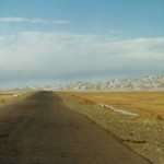 open road into the horizon in Gobi desert, Mongolia book