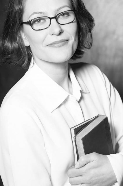 Smiling woman holding books