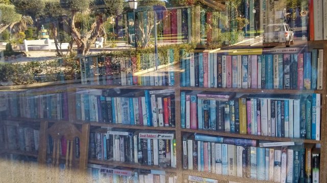 Small library closed, window reflection of park