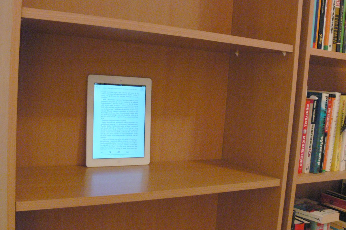 Apple iPad on bookshelf with books