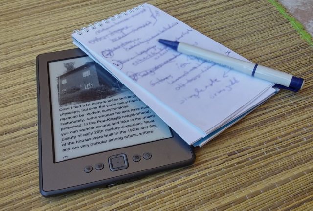 Kindle ereader, notepad, pen