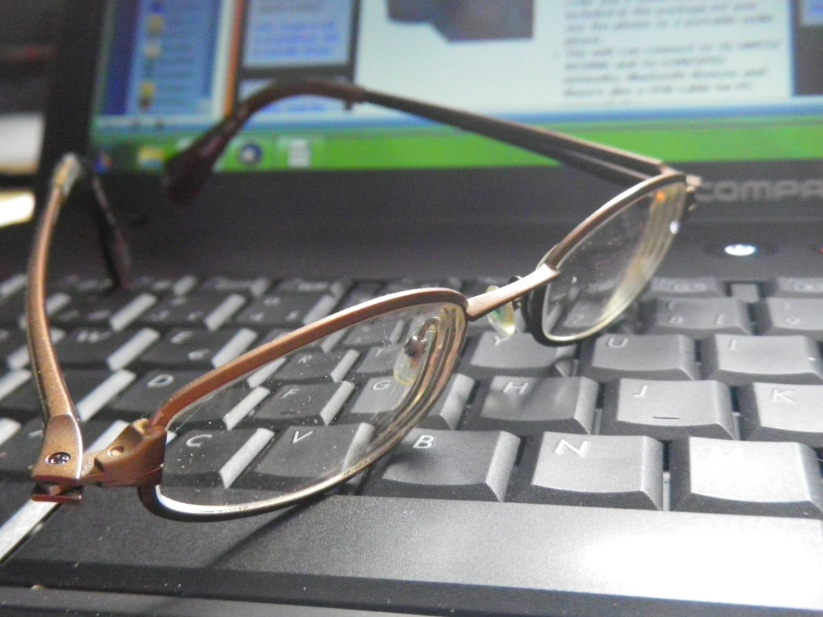 writer's eyeglasses on computer keyboard