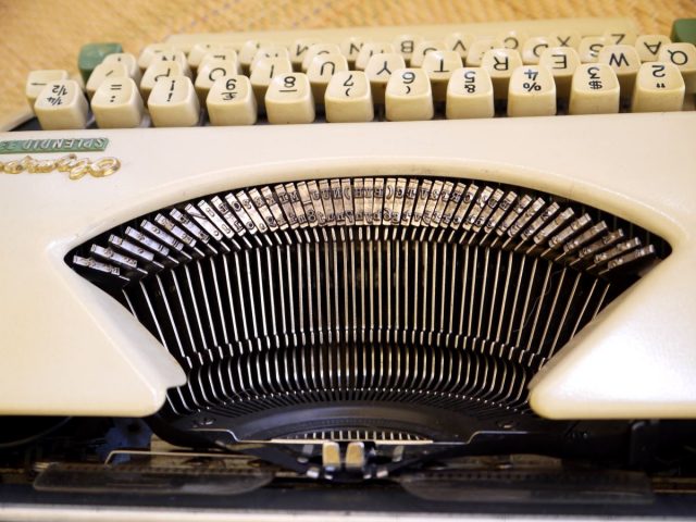 letters on heads of metal arms in typewriter