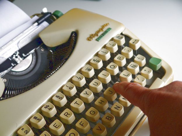 mechanical typewriter, finger pushing a key, writing, typing