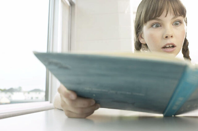 girl student amazed about the content of a book