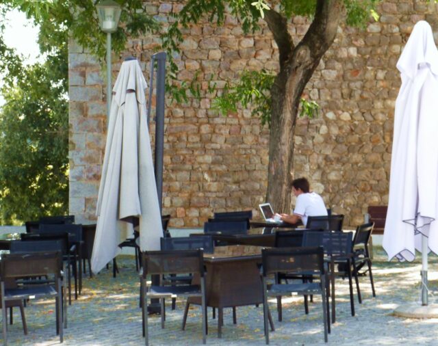 digital nomad working on his laptop in Tavira, POrtugal