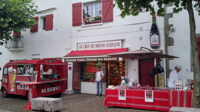 espelette village in france, basque region: a shop with chef and bar on the pavement