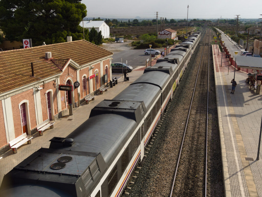 train at a station in the countryside. nice old train station building.