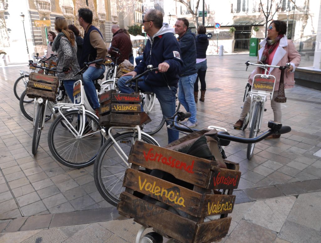 tourists on a guided bicycle tour in the city of valencia in spain.