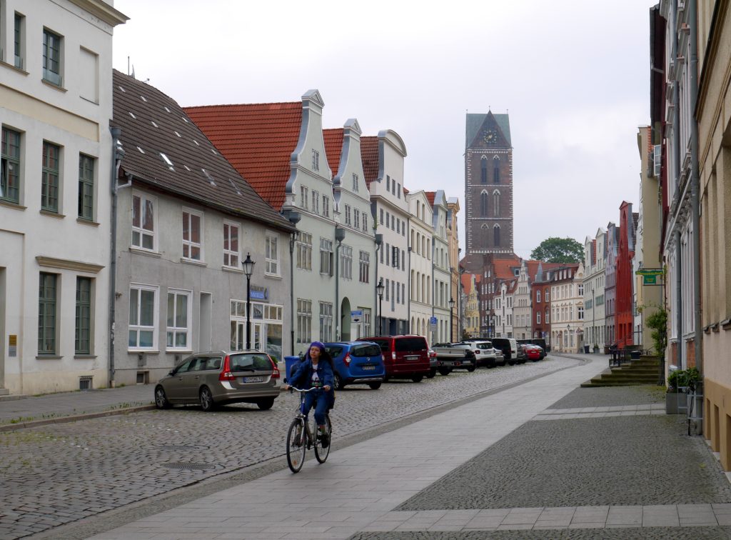 woman cycling in the town center of wismar.