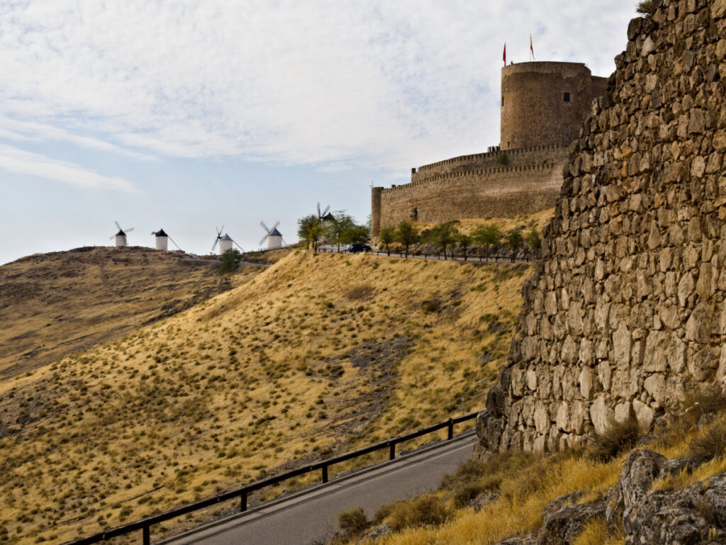 historic castle and windmills in consuegra, spain